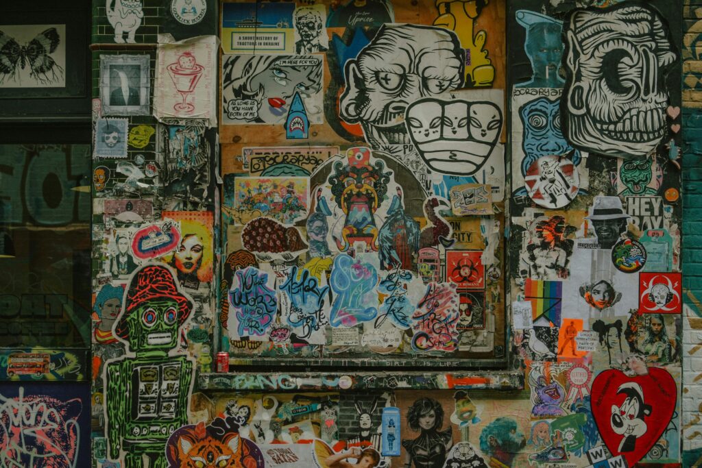 Wall covered in colorful graffiti art and stickers